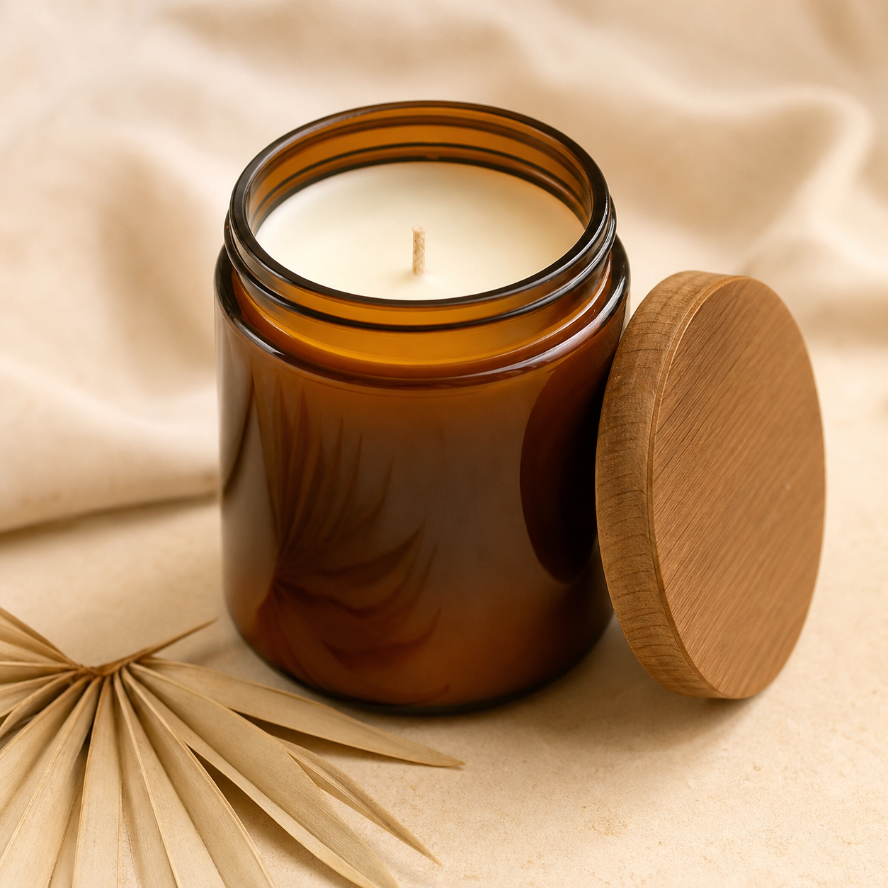 Amber glass coconut soy candle on a cream surface